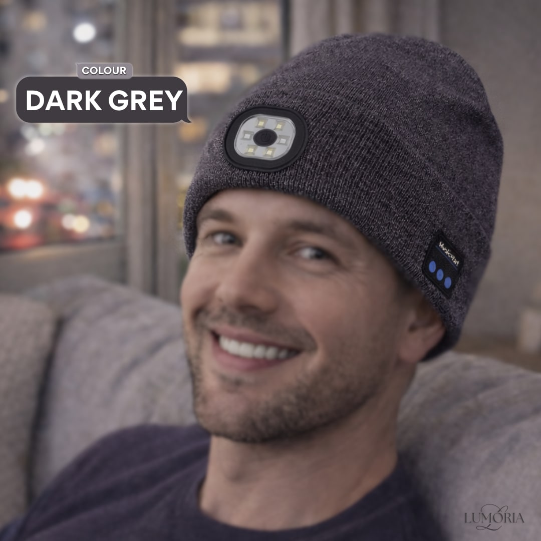 Man wearing the GlowSound Beanie™ in dark grey with Bluetooth audio and built-in LED light for everyday indoor comfort