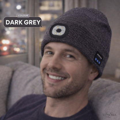 Man wearing the GlowSound Beanie™ in dark grey with Bluetooth audio and built-in LED light for everyday indoor comfort